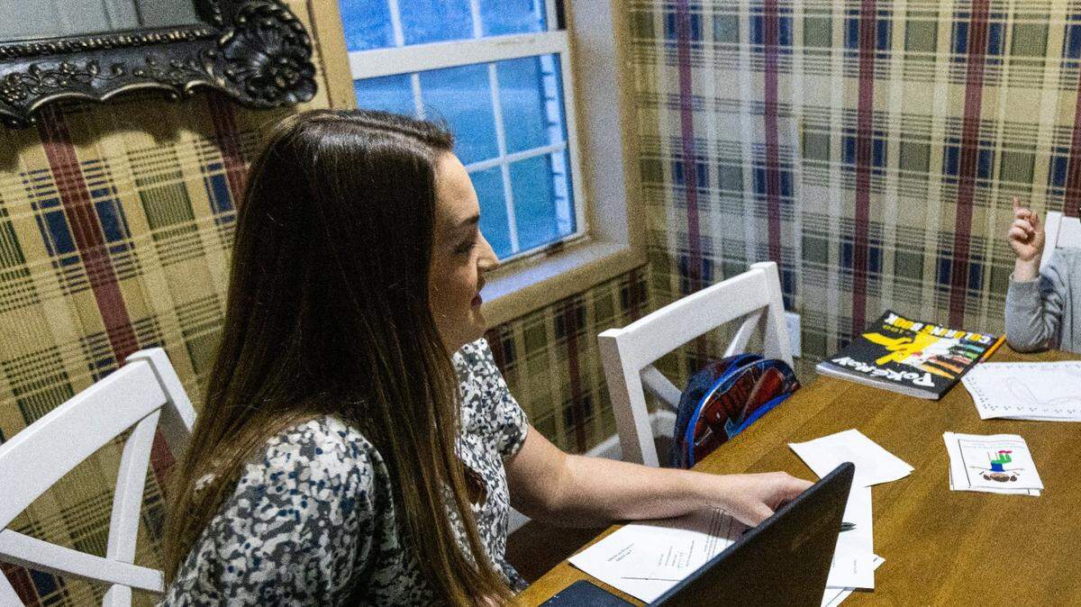 Judge executive candidate Heather Baldwin, left, assists two of her children with schoolwork at their home in Lincoln County March 8, 2022.