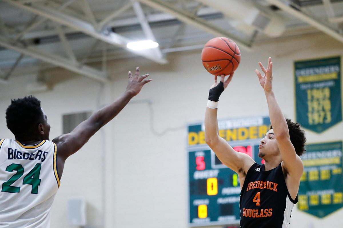 Kai Simpson (4) shoots over Bryan Station’s Jaden Biggers (24) on Tuesday night. Simpson scored a game-high 24 points to help lead Frederick Douglass to the postseason win.