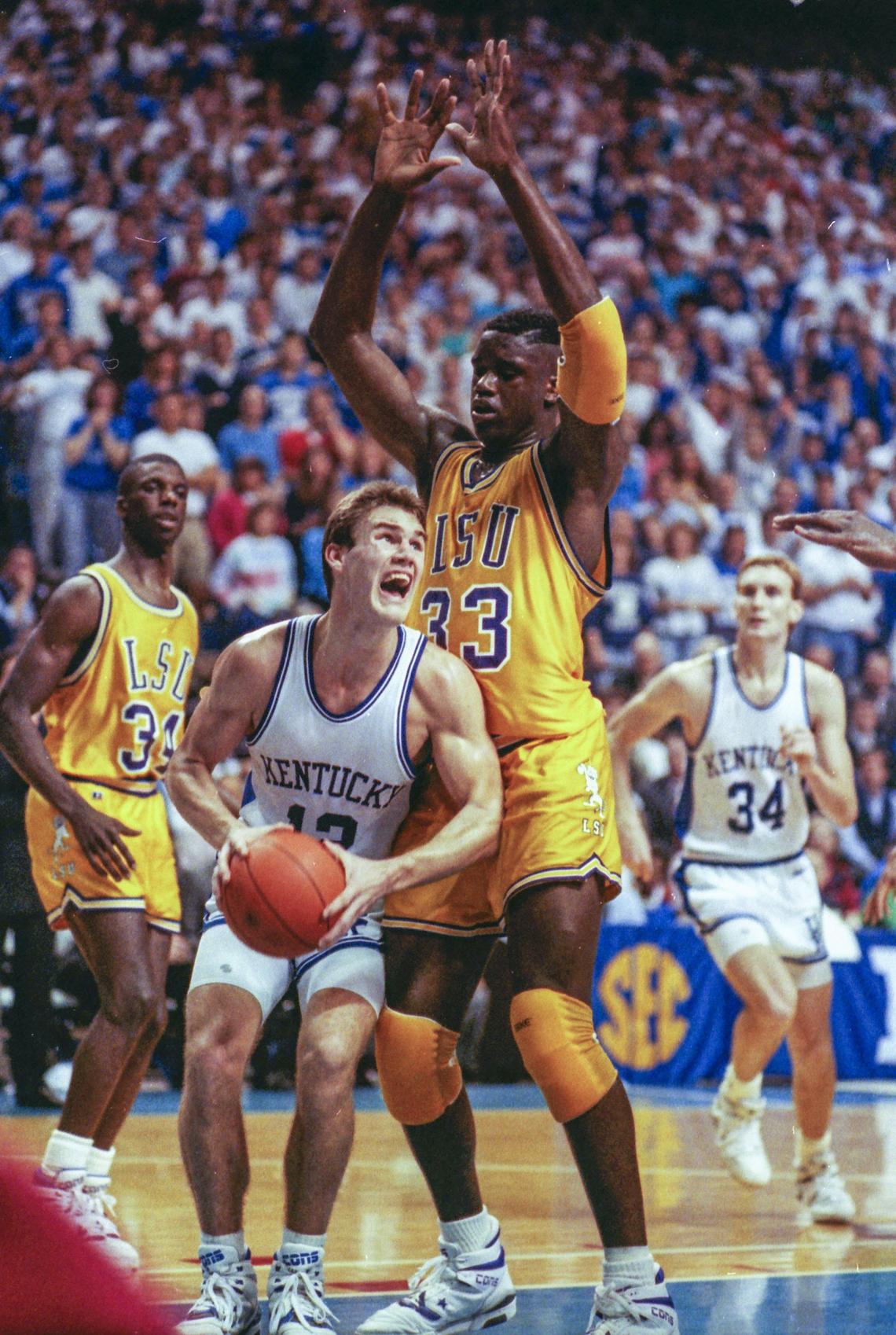 Kentucky’s Deron Feldhaus was guarded by Louisiana State’s Shaquille O’Neal as UK beat LSU 100-95 in Rupp Arena on Feb. 15, 1990.