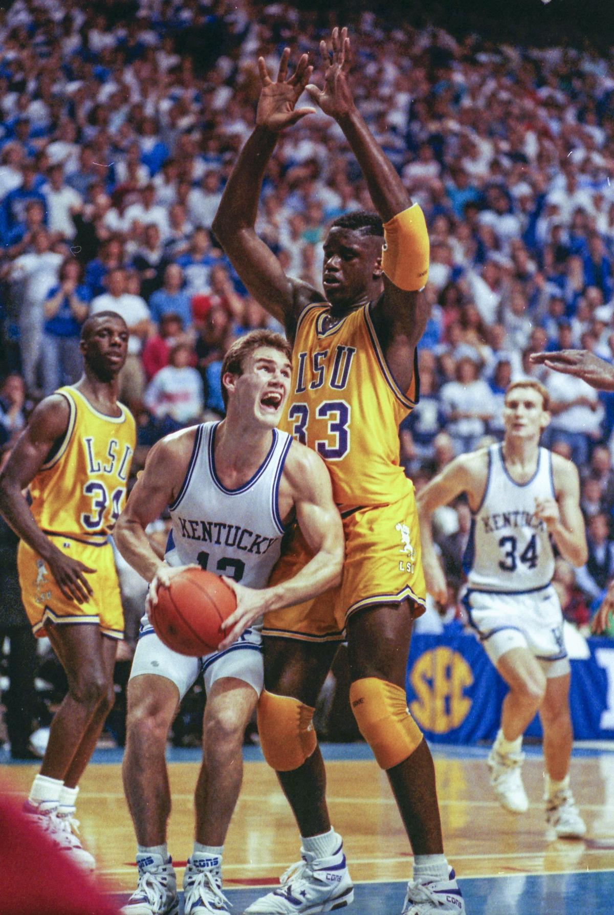Kentucky’s Deron Feldhaus was guarded by Louisiana State’s Shaquille O’Neal as UK beat LSU 100-95 in Rupp Arena on Feb. 15, 1990.