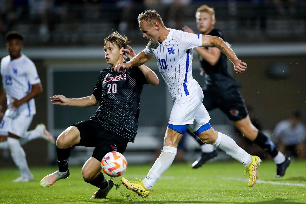 Kentucky midfielder Casper Grening (10) shoots past Louisville forward Nico Diaz (20) for a second-half goal Tuesday night in Lexington.