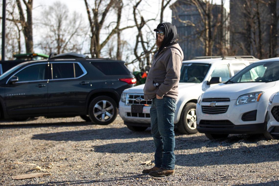 Chris Chism, 33, waits for news of his mother in a parking lot near Mayfield Consumer Products on Saturday, Dec. 11, 2021. ChismÕs mother was at work at the candle factory that was demolished by a tornado Friday night.