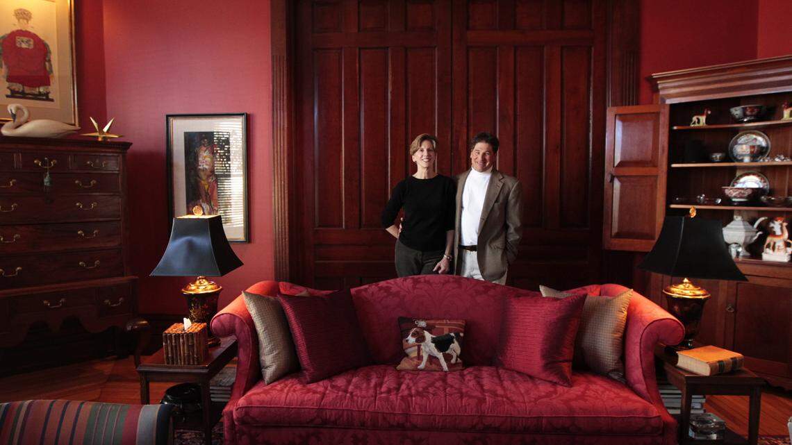 Red is the dominant color in the living room of the West High Street home of Fran Taylor and Tom Cheek of Lexington. The pocket doors go almost all the way to the top of the 12-foot ceiling.