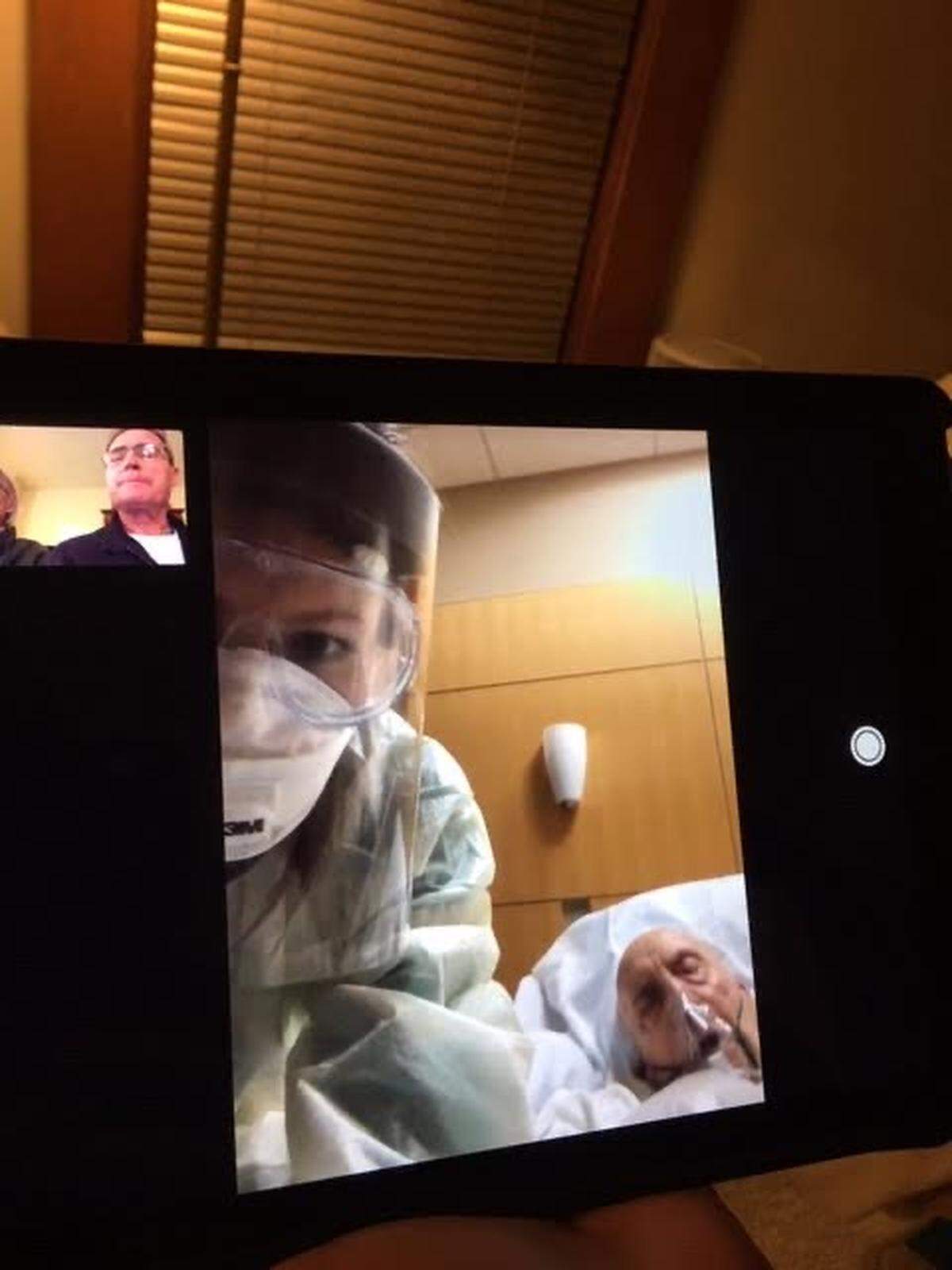 A photo of the screen from a FaceTime chat that Lexington nurse Ellie Schroader, foreground, set up for her coronavirus patient, Bob Green, from an Ohio hospital with his son, Thom Green, in Minnesota.