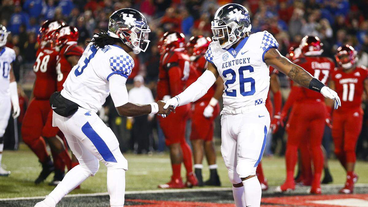 Kentucky’s Terry Wilson, left, and Benny Snell celebrated a touchdown against Louisville.