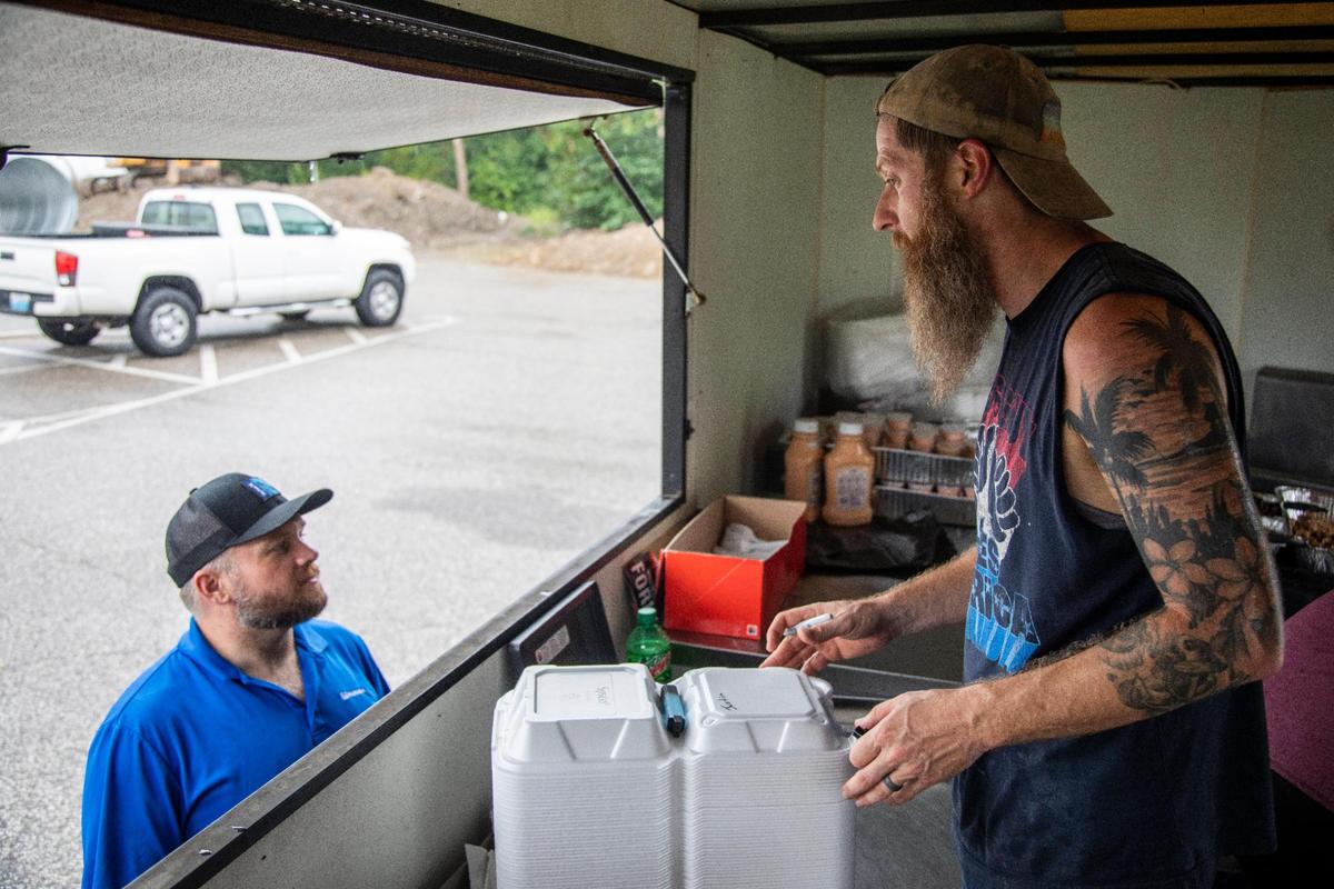 Co-owner Adam Brown helps customers in the Hillbilly Hibachi food truck in Ashland. Co-owner Travis York and Brown met playing pick-up basketball in 2014. York was a head basketball coach in Lawrence County and Brown was going through rehab for drug addiction and regained his childhood passion for cooking in the process.
