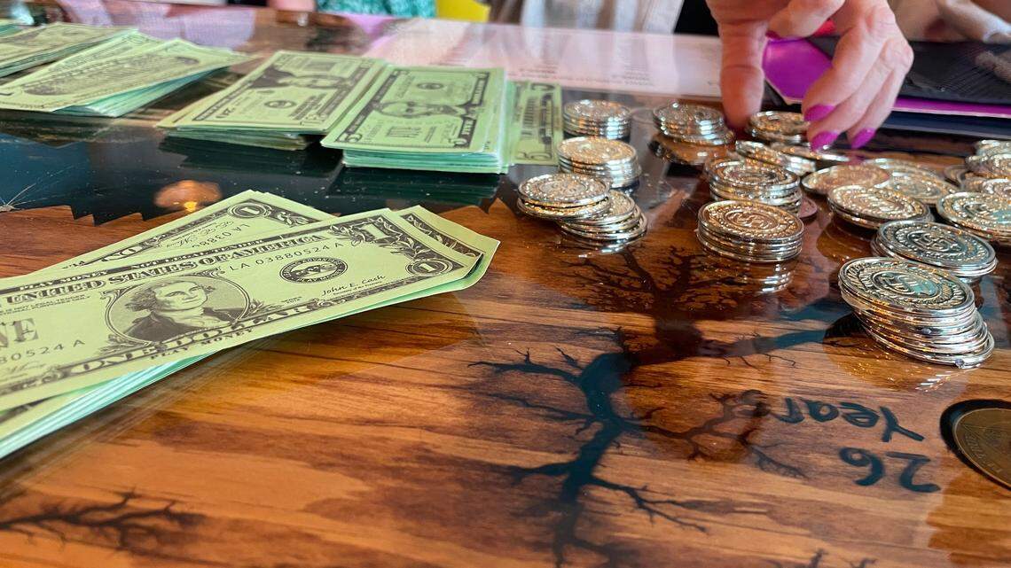 Tables were set up at a re-entry simulation event where bus tokens were purchased for transportation. The event was intended to show people how difficult it is to re-enter society after being jailed.