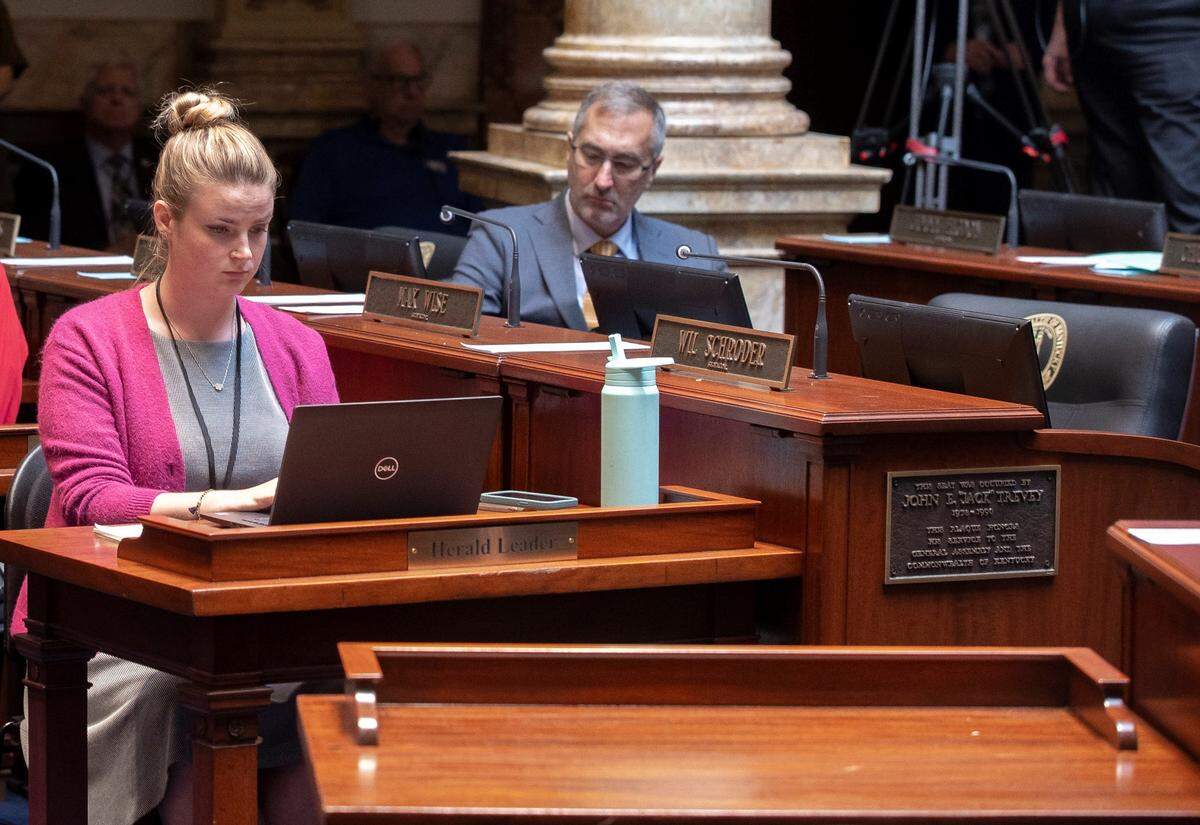 Lexington Herald-Leader Frankfort bureau chief Tessa Duvall at her desk on the floor of the Senate Chambers in the State Capitol in Frankfort, Ky.