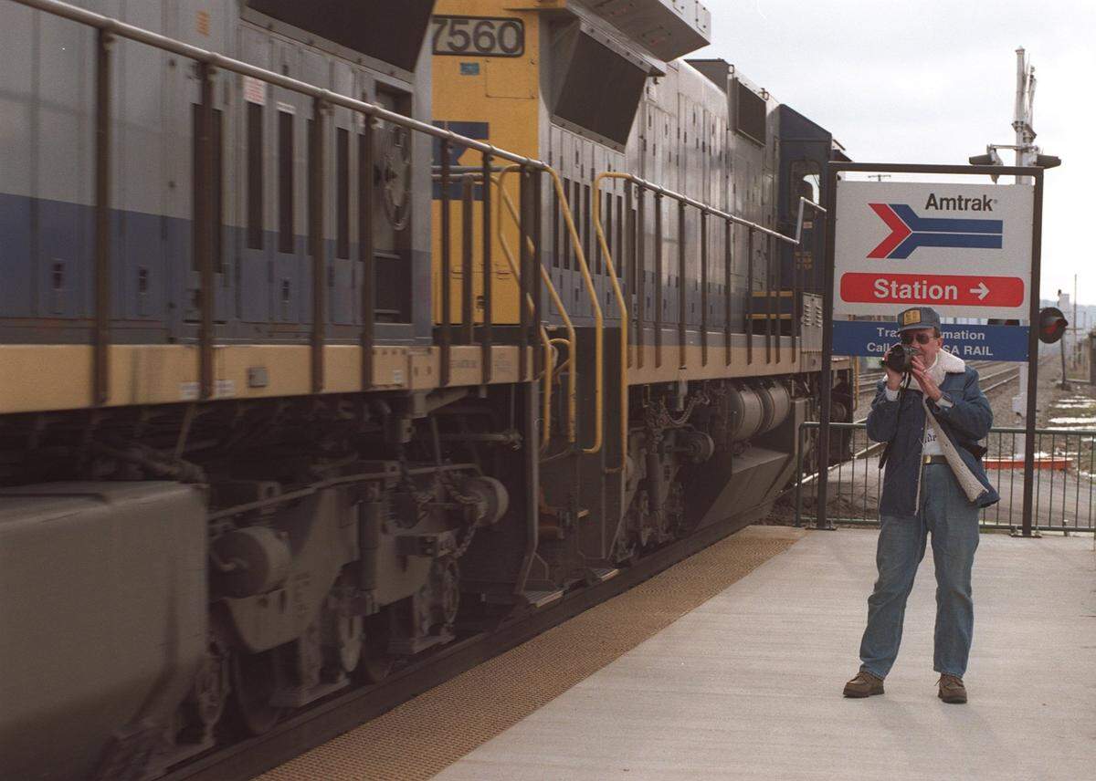 The scheduled return of Amtrak passenger train service to Ashland was postponed this morning, Wednesday March 11, 1998. The train was stranded up north due to bad weather but the ceremony marking the return was held anyway at the new Ashland Transpotation Center located at 15th St and the Ohio Riverfront in downtown Ashland. SEE STORY- Don Childers came to video the passenger train but had to settle for a passing coal train. He worked for the railroad in Ashland for 37 years and is one of 4 generations of his family to work for railroads