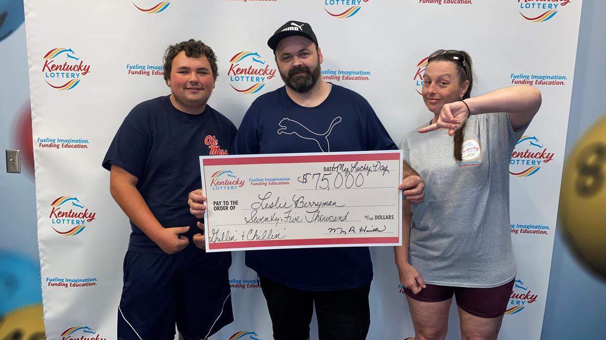 Leslie Berryman, middle, poses with others recently at Kentucky Lottery headquarters after winning $75,000 on a scratch-off ticket in June.
