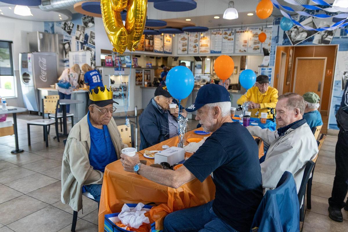 John Hughes, a World War II veteran, celebrated his 99th birthday with friends he regularly gathers with for breakfast at White Castle on East Reynolds Road, May 31, 2025.