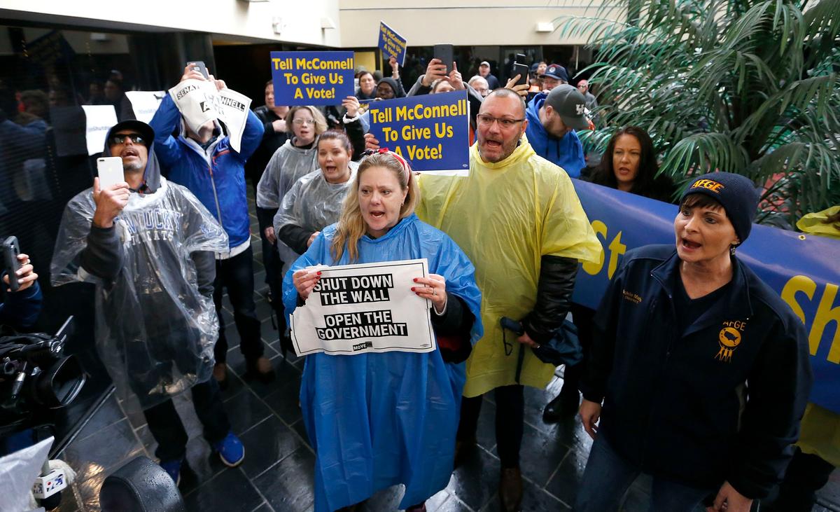 Federal employees and supporters held a rally Wednesday outside U.S. Senator Mitch McConnell’s Lexington office on Corporate Drive.