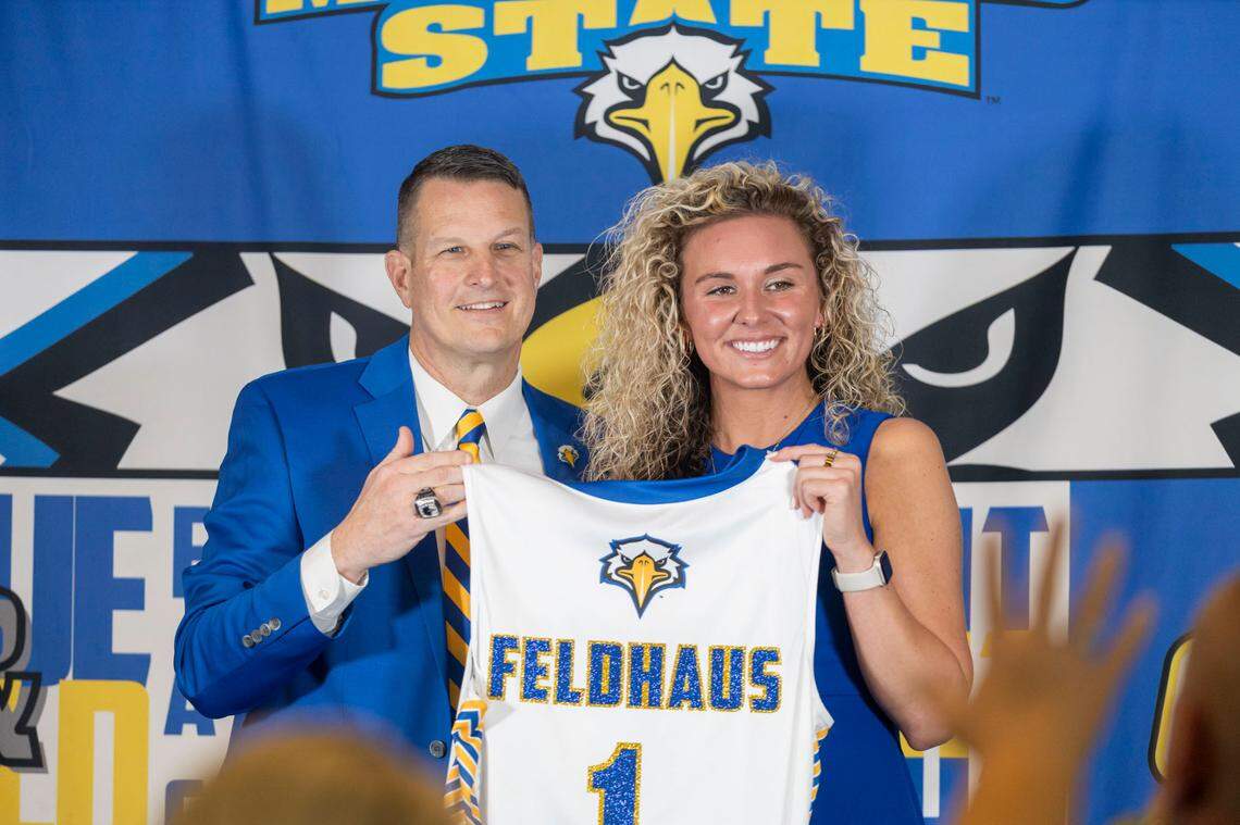 Morehead State athletics director Kelly Wells, left, presented Ashton Feldaus with an MSU jersey upon her introduction as the new Eagles women’s basketball head coach.