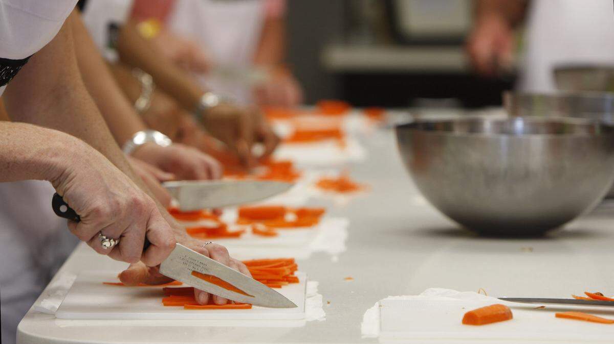 Students julienned carrots during a cooking class at Wild Thyme in Lexington. Allison Davis teaches a range of classes.