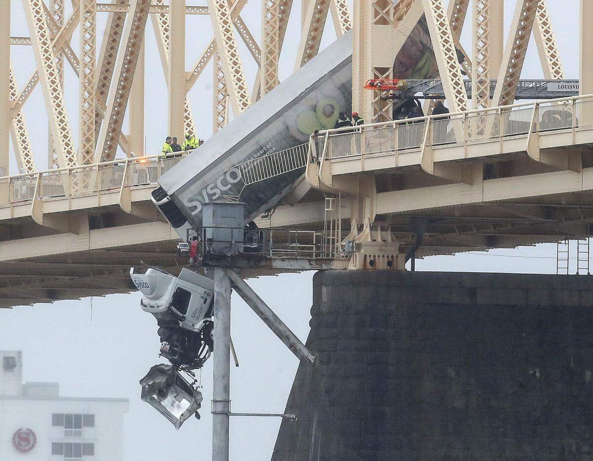 March 1, 2024; Louisville, KY, USA; A semi-truck dangles over the southbound lane of the Second Street Bridge Friday afternoon. One person was rescued from the vehicle.  Mandatory Credit: Matt Stone-USA TODAY NETWORK  