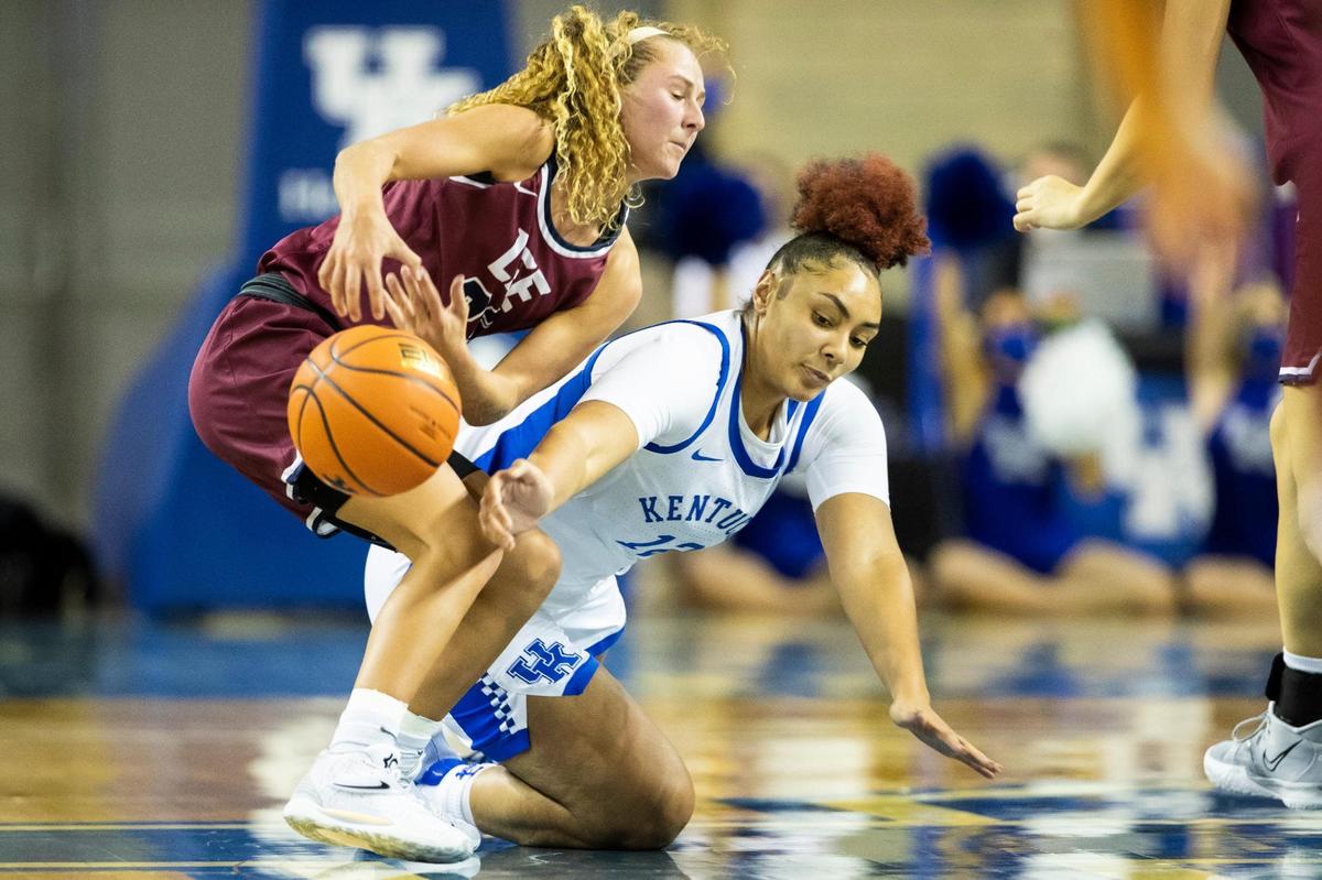 Kentucky’s Treasure Hunt (12) dives to steal the ball from Lee University’s Haley Schubert (33) during Thursday night’s exhibition.