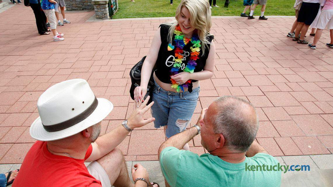 Lauren Engle, wearing a T-shirt thats said Groom, places toy wedding bands on everyone's fingers at the Decision Day Rally, celebrating today's marriage equality ruling, at Robert Stephens Courthouse Plaza in Lexington, Ky., Friday, June 26, 2015. Photo by Matt Goins
