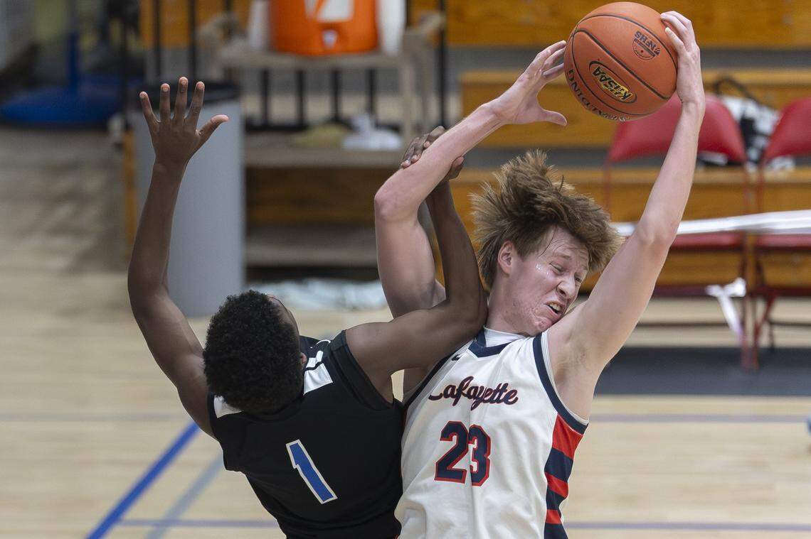 Lafayette's Tyler Hunt (23) rebounds the ball over Lexington Christian's William Coffman (1) during a game at Lafayette High School in Lexington, Ky., on Tuesday, Feb. 10, 2026.