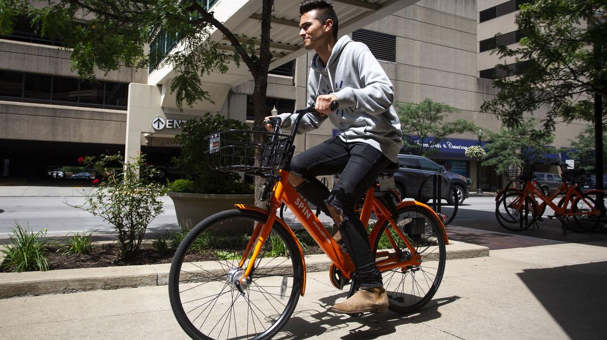 Erik Zamudio, 26, rides a Spin bike back to work after riding downtown to eat lunch in Lexington on Thursday.