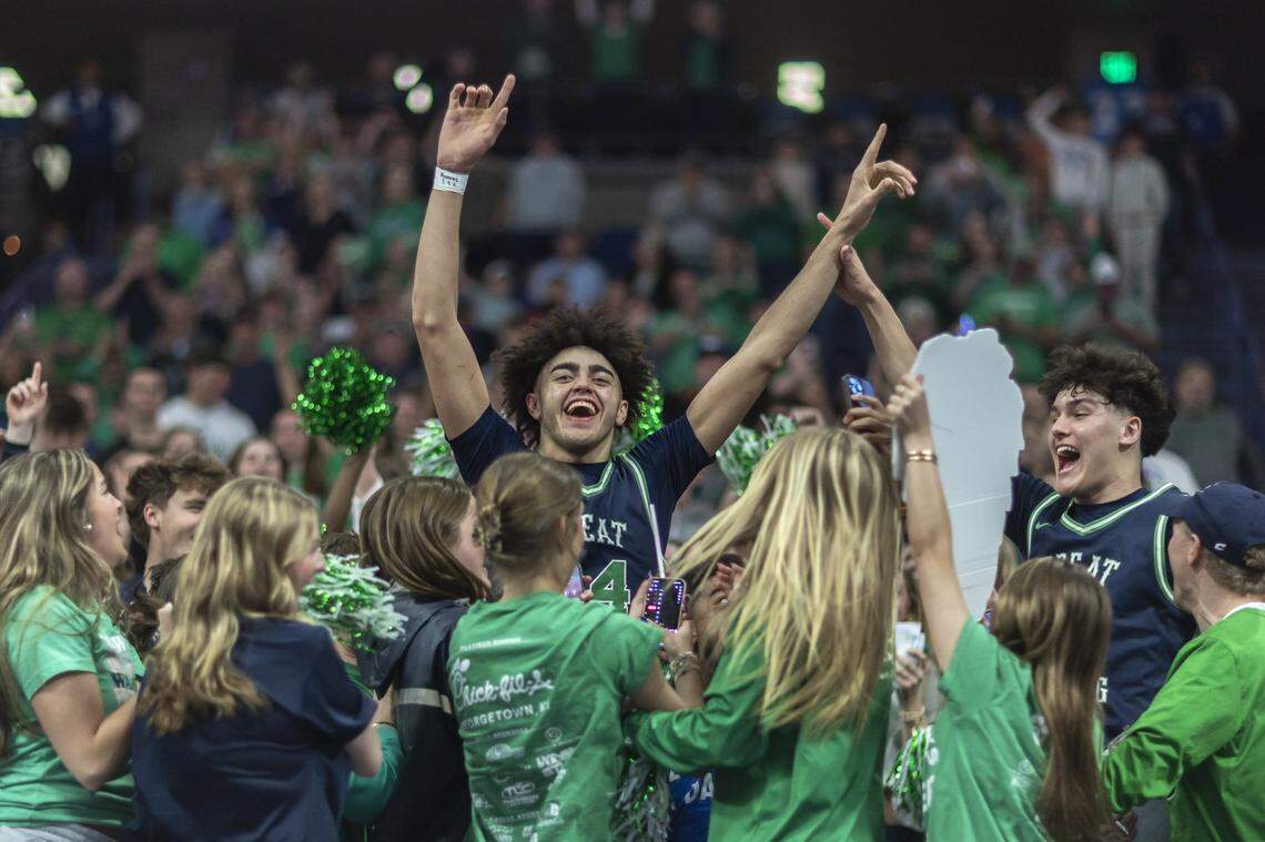 Great Crossing center Malachi Moreno (24) went into his school’s student section in the Rupp Arena stands to celebrate after the Warhawks beat Bowling Green 71-61 in the finals of the 2025 Kentucky Boys Basketball State Tournament.