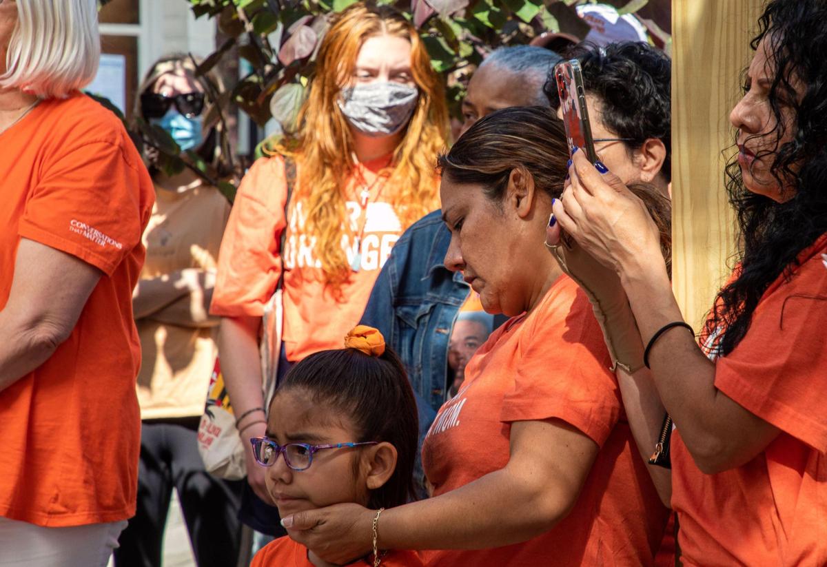 Gun violence survivor Claudia Gomez and her daughter listened to speakers at a rally against gun violence held Friday by Moms Demand Action at Sav’s Restaurant.