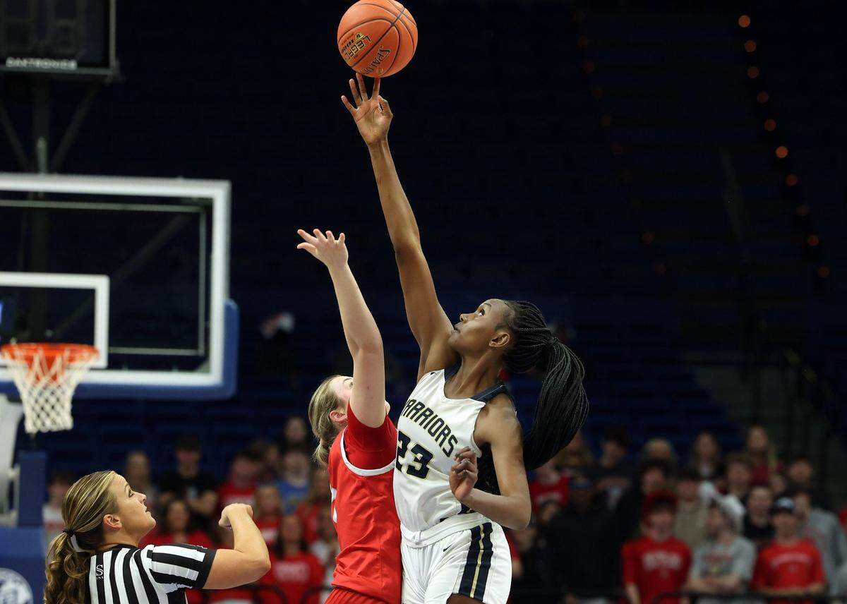 Grace Mbugua (23) controls the tipoff against Daviess County during Danville Christian’s 53-40 win to wrap up the first round of the Girls’ Sweet 16 in Rupp Arena on Thursday night. The 6-foot-5 Mbugua has committed to play college basketball at Louisville.