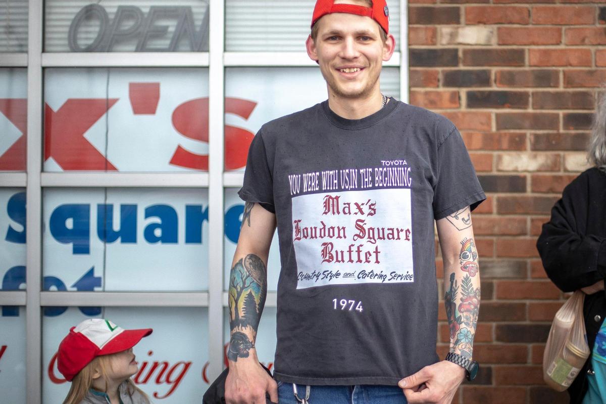 Nathan Stacy of Lexington, with his daughter Taylor, 3, wait for Max’s Loudon Square Buffet to open on its last day of business on Friday, April 8, 2022. Stacy’s fiancee made him a shirt honoring the longtime restaurant.