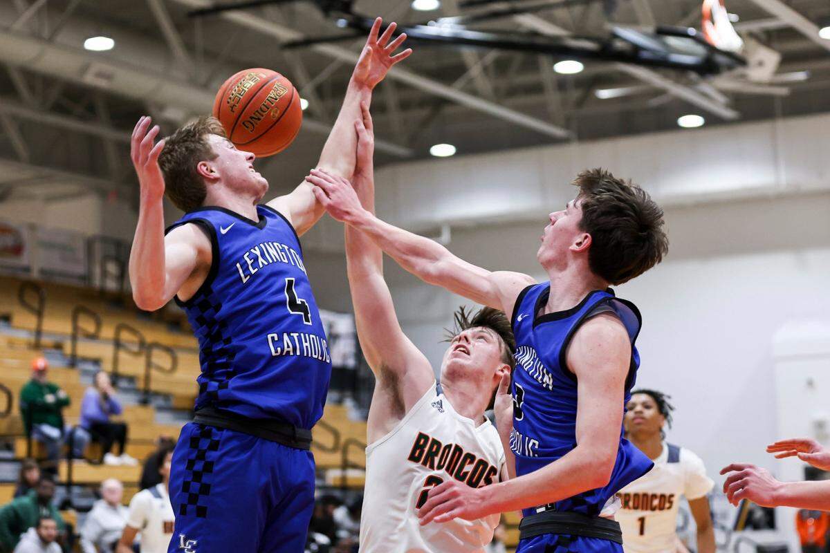 Lexington Catholic’s John Reinhart (4) blocks a shot against Frederick Douglass during a game on Feb. 14.