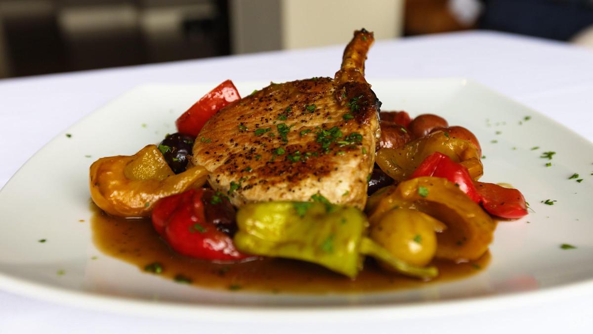 The Braciola Di Maiale Scarpariello pork chop is pan roasted, topped with potatoes, sausages, pepper, black olives and a touch of balsamic vinegar.