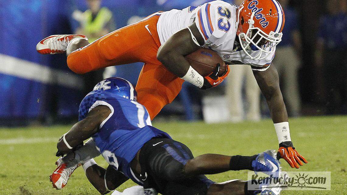 Kentucky Wildcats cornerback Cody Quinn (16) tackles Florida Gators running back Mack Brown (33) during the second half as Kentucky plays Florida in Lexington, Ky. Photo by Amy Wallot