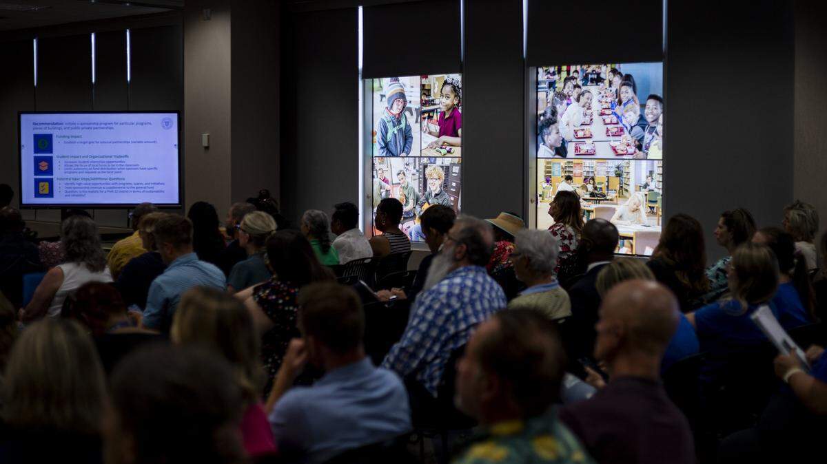 Attendees sit and listen during a school board meeting on Monday, Aug. 18, 2025, at Fayette County Public Schools Central Office in Lexington, Ky. 