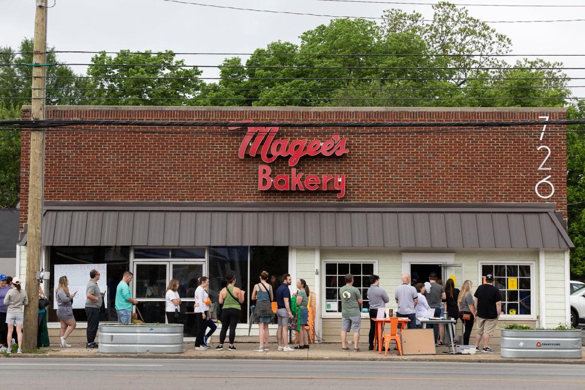 Patrons gather and line up around the corner of South Ashland Avenue and Main Street to try and purchase something on the last day of business for Magee’s Bakery in Lexington, Ky., Saturday, May 13, 2023. Some people waited in line over two hours.