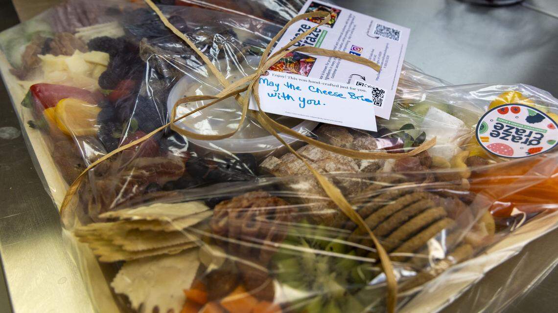 A wrapped medium Gone Grazey board at Graze Craze, Wednesday, Dec. 10, 2025, in Lexington, Ky. The price for the medium-sized charcuterie board is $135 and feeds up to 15 people. Trays come with a selection of homemade dips like roasted red pepper hummus and lemon dill mayo. Dips and jams are also sold separately. 