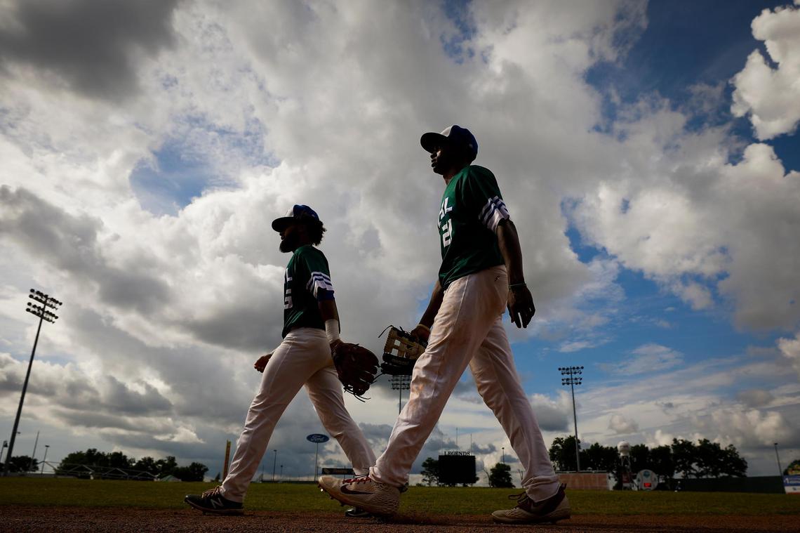 Xpress Green team players Tyson Proffit (5) and Antonio Chambers (21) took the field before their Commonwealth Collegiate Baseball League game against the Xpress Gold team at Whitaker Bank Ballpark on Tuesday night. Gold beat Green 13-3 in seven innings.