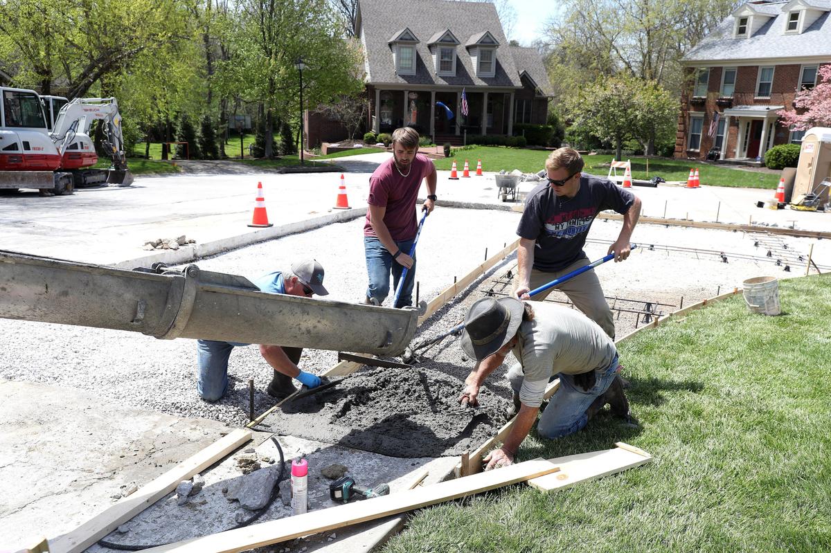 Rick Hembree, left, his son Seth Hembree, Jimmy Eldridge and Jacob Francisco from Sensabaugh Design and Construction replaced a section of concrete pavement for the city of Lexington Wednesday afternoon on Taborlake Drive.