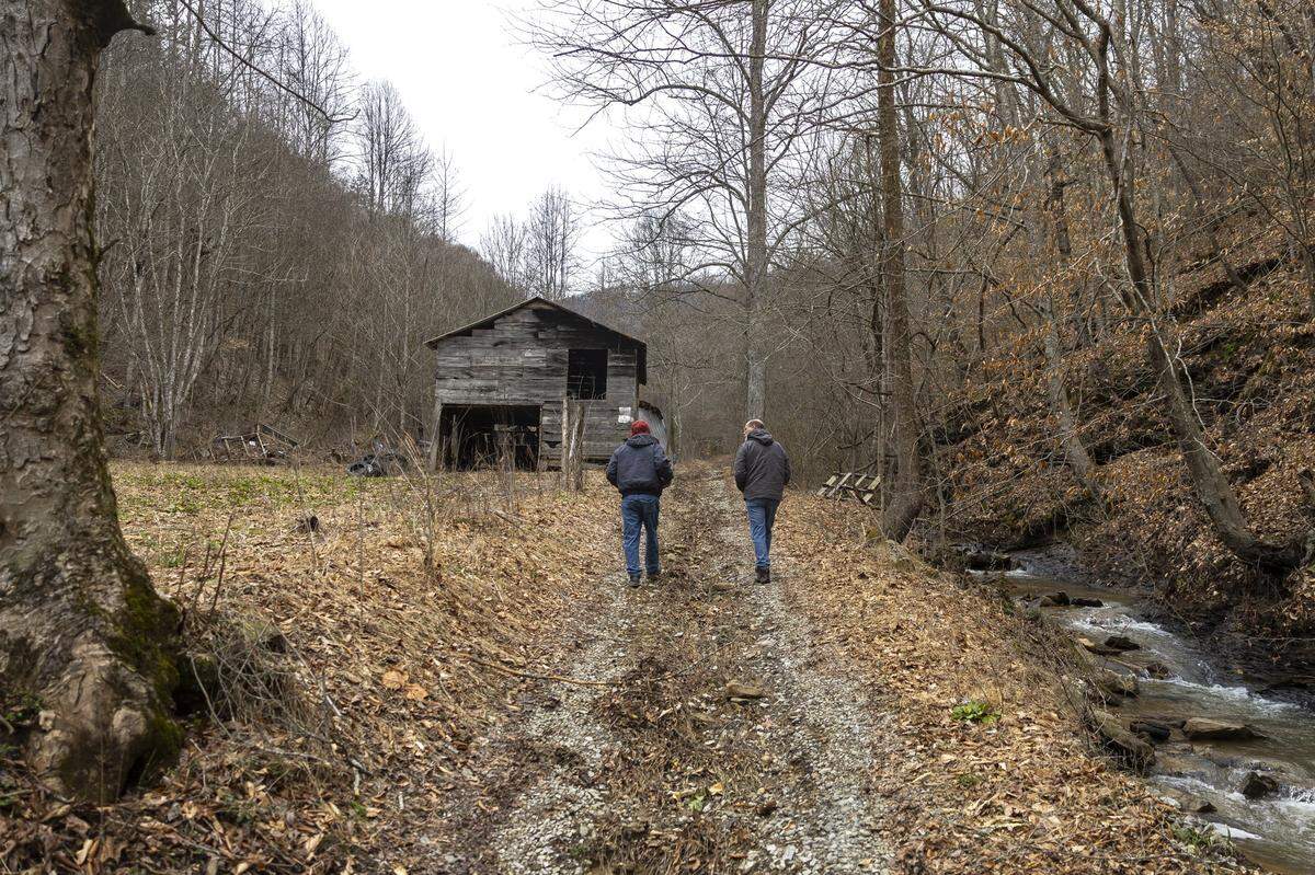 Lexington Herald-Leader reporter Bill Estep interviews Phillip Johnson on his property in Pike County, Ky., on Tuesday, Feb. 18, 2025.