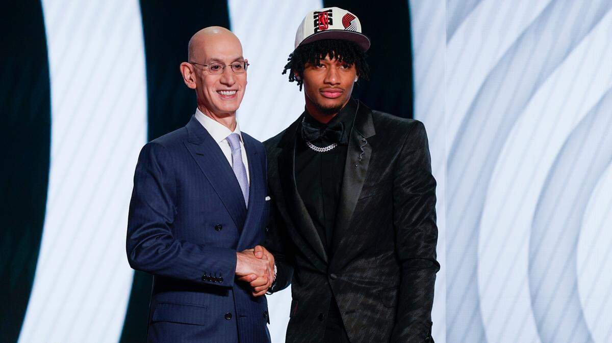 Shaedon Sharpe, right, shakes hands with NBA Commissioner Adam Silver after being selected seventh overall by the Portland Trailblazers in the NBA basketball draft, Thursday, June 23, 2022, in New York. (AP Photo/John Minchillo)