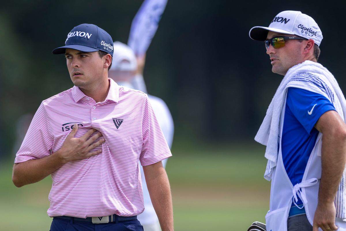 Former Kentucky men’s golfer Alex Goff speaks to his caddie, current UK men’s golf assistant coach Chip McDaniel, on the 18th hole during the first round. Goff made his PGA Tour debut this week at the event.