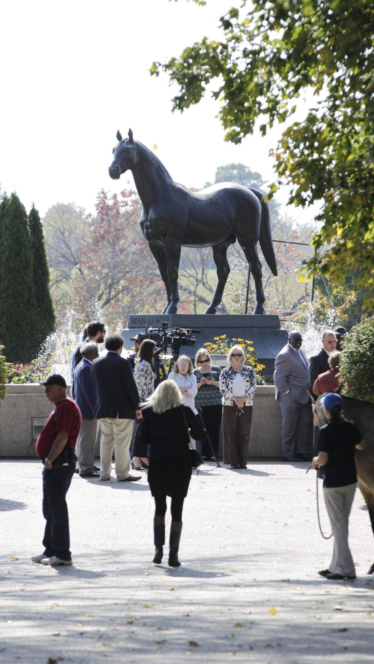 People gathered for the unveiling of the newly engraved headstone  of Isaac Burns Murphy during a ceremony at the Kentucky Horse Park  in Lexington, Ky., on Oct. 22, 2015. The memorial is near the  statue of Man O War. 
