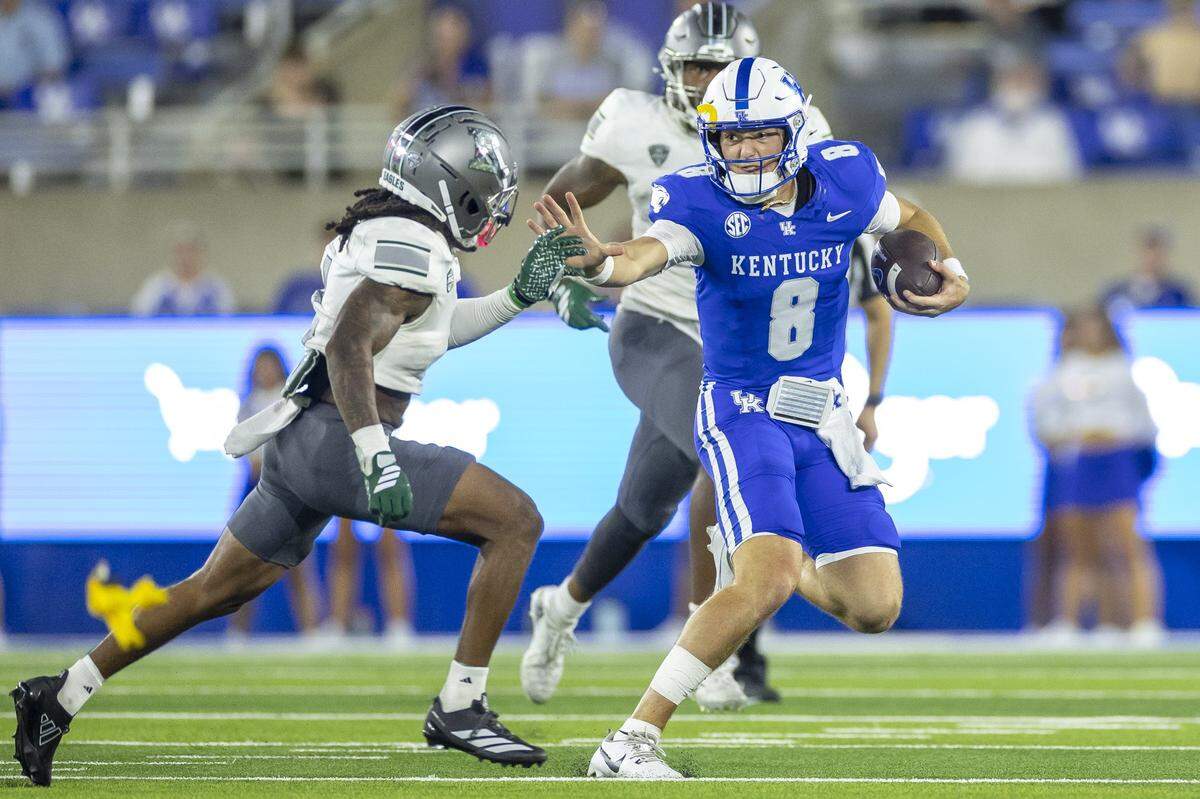 Kentucky quarterback Cutter Boley (8) runs the ball as Eastern Michigan’s Juan Salas Jr. chases during Saturday’s game at Kroger Field.