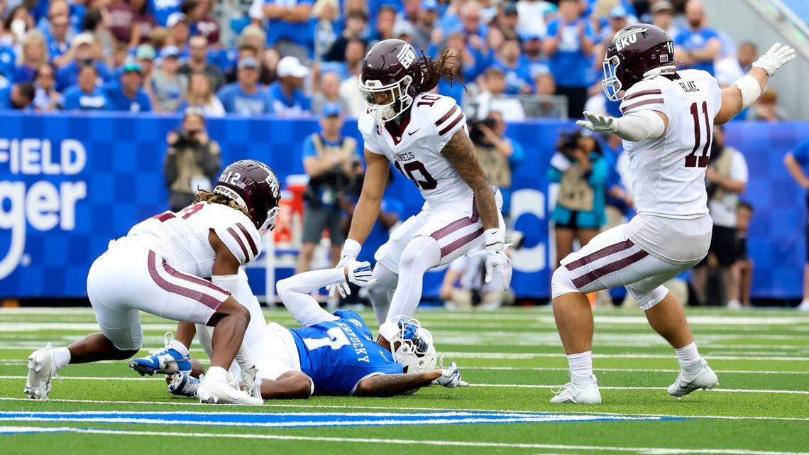 Kentucky wide receiver Barion Brown (7) dropped a pass while under pressure from Eastern Kentucky defensive back Deonta Bembry (12), defensive back Nic Cheeley (10) and linebacker Logan Blake (11) during Saturday’s game at Kroger Field.