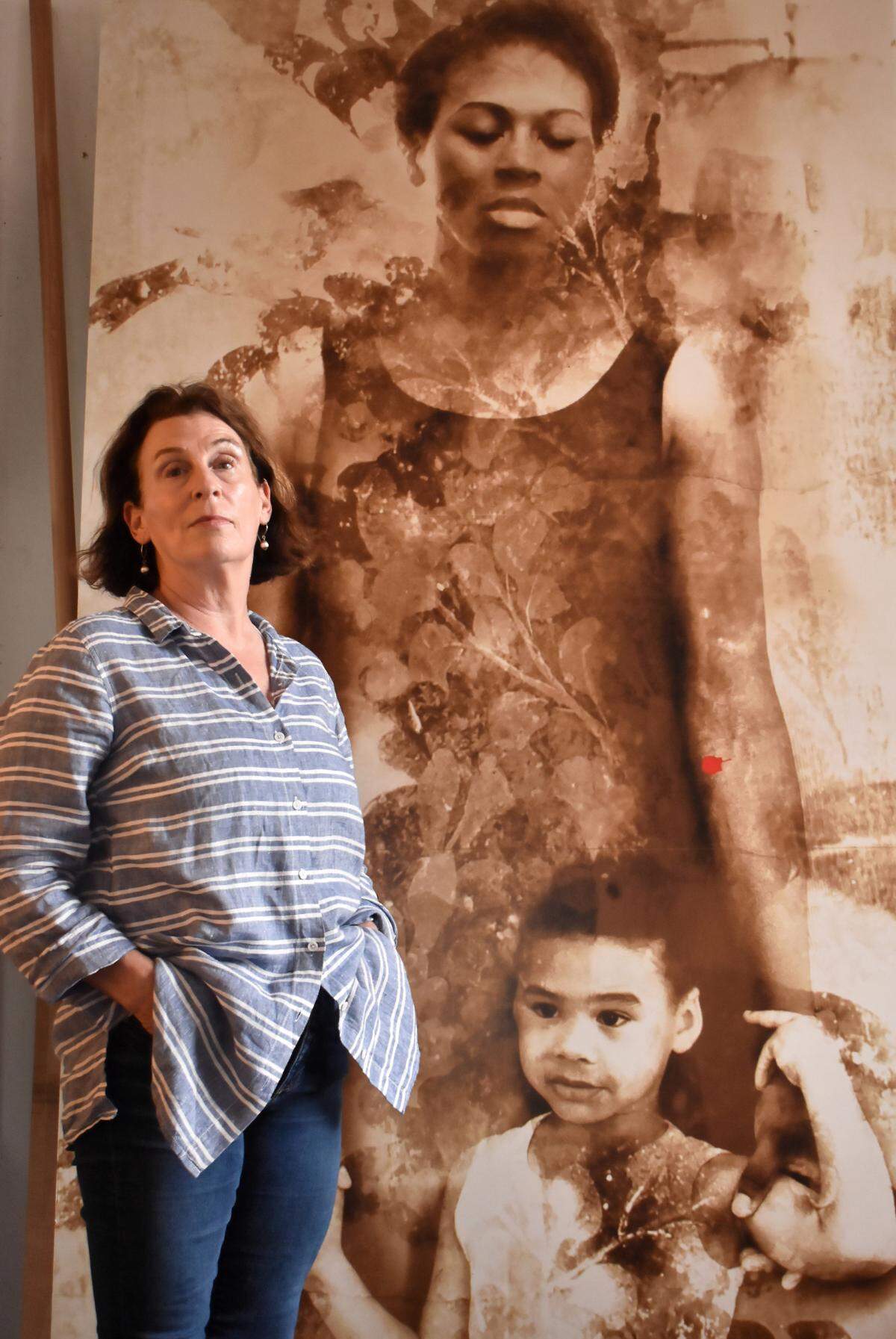 Artist Majorie Guyon with one of the tapestries created for the “i was here” project, an art installation around Cheapside in Lexington that is expanded to more locations.
