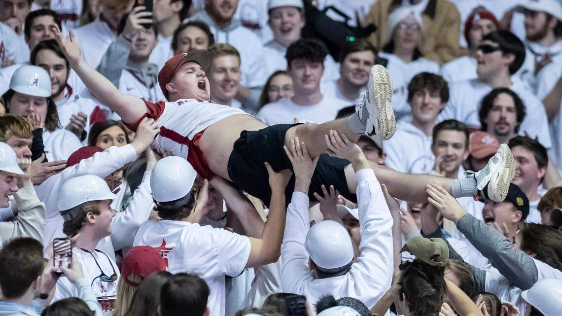 An Alabama fan crowd-surfs during the Crimson Tide’s upset of fourth-ranked Baylor in Tuscaloosa on Saturday.