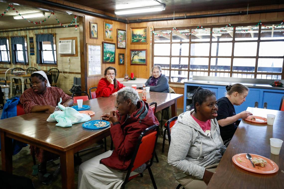 A few of the Galilean Home’s 30 full-time residents gather for lunch in the dining hall at the home in Liberty, Ky., Monday, Dec. 20, 2021.