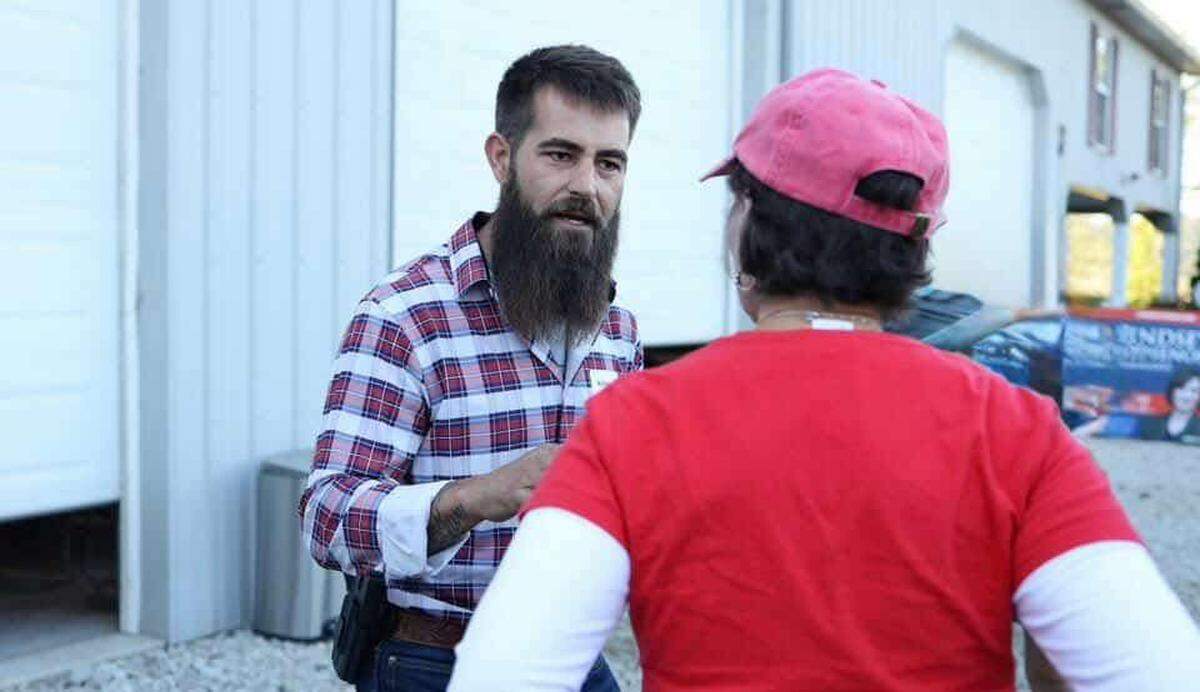 U.S. Senate candidate Michael Faris speaks to a Republican at a party event.