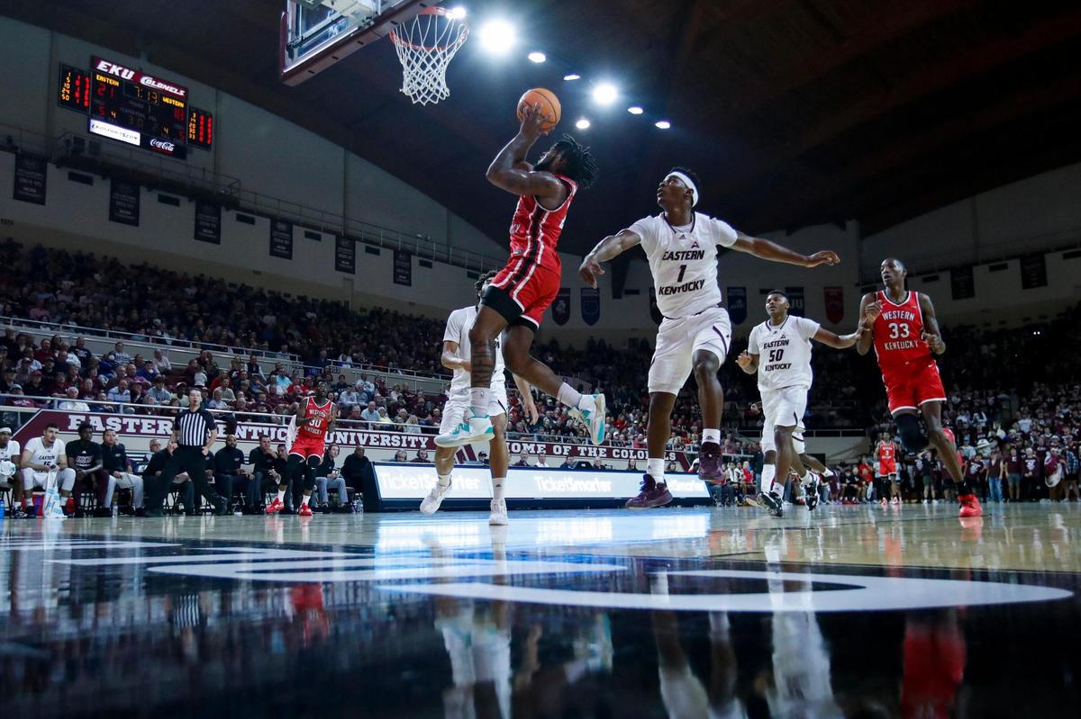 Western Kentucky Hilltoppers guard Dayvion McKnight (20) drives to the basket around Eastern Kentucky Colonels guard Tayshawn Comer (1) during the game at McBrayer Arena in Richmond, Ky., Thursday, November 10, 2022.