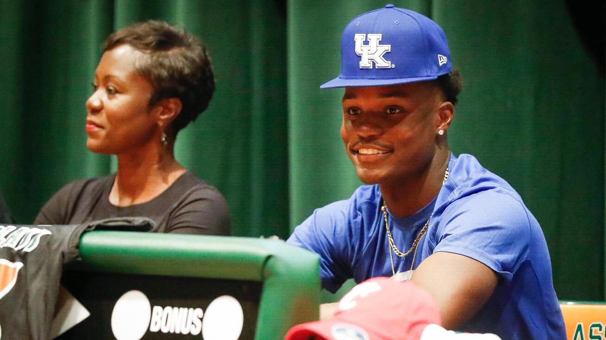 Frederick Douglass football player Ty Bryant, right, commits to the University of Kentucky at FDHS in Lexington, Ky., Thursday, Aug. 18, 2021.
