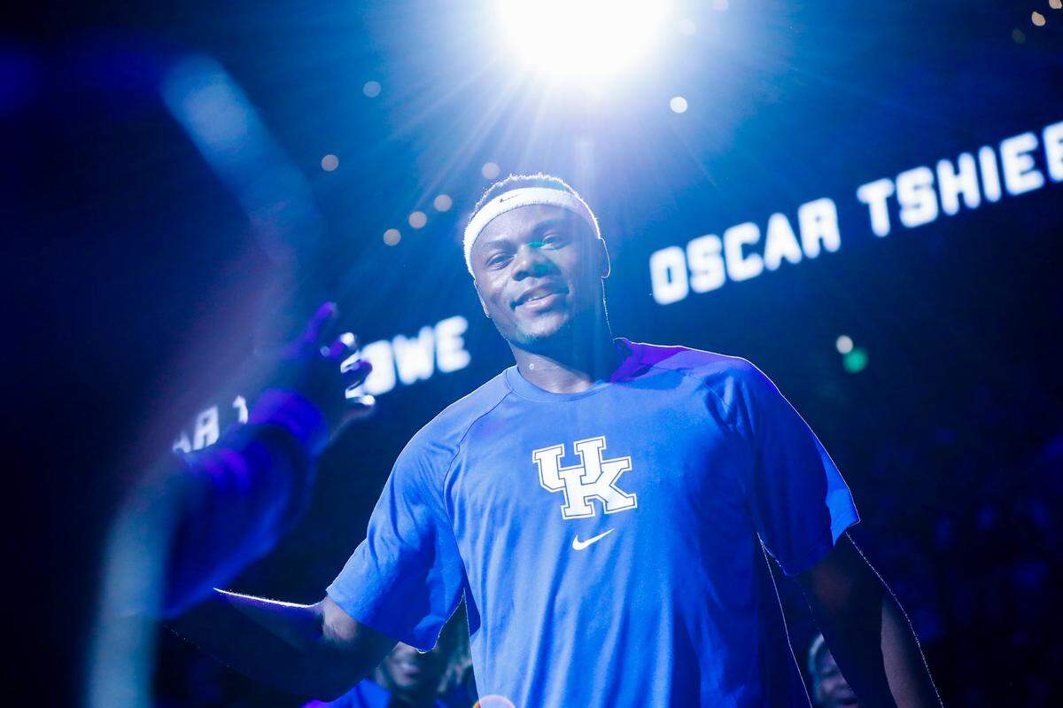 Kentucky basketball star Oscar Tshiebwe runs onto the Rupp Arena court during player introductions before a game earlier this season.
