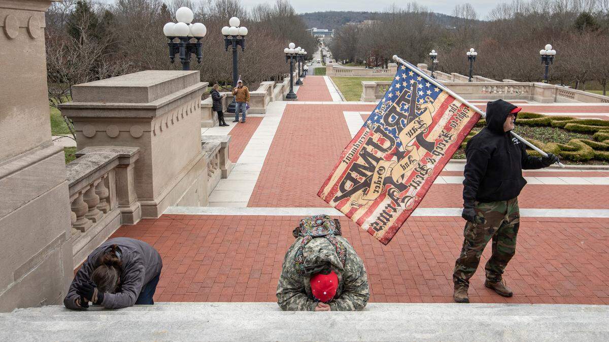 ‘Stop the steal’ protesters prayed on the steps outside the Kentucky state Capitol Wednesday, Jan. 6, 2021.