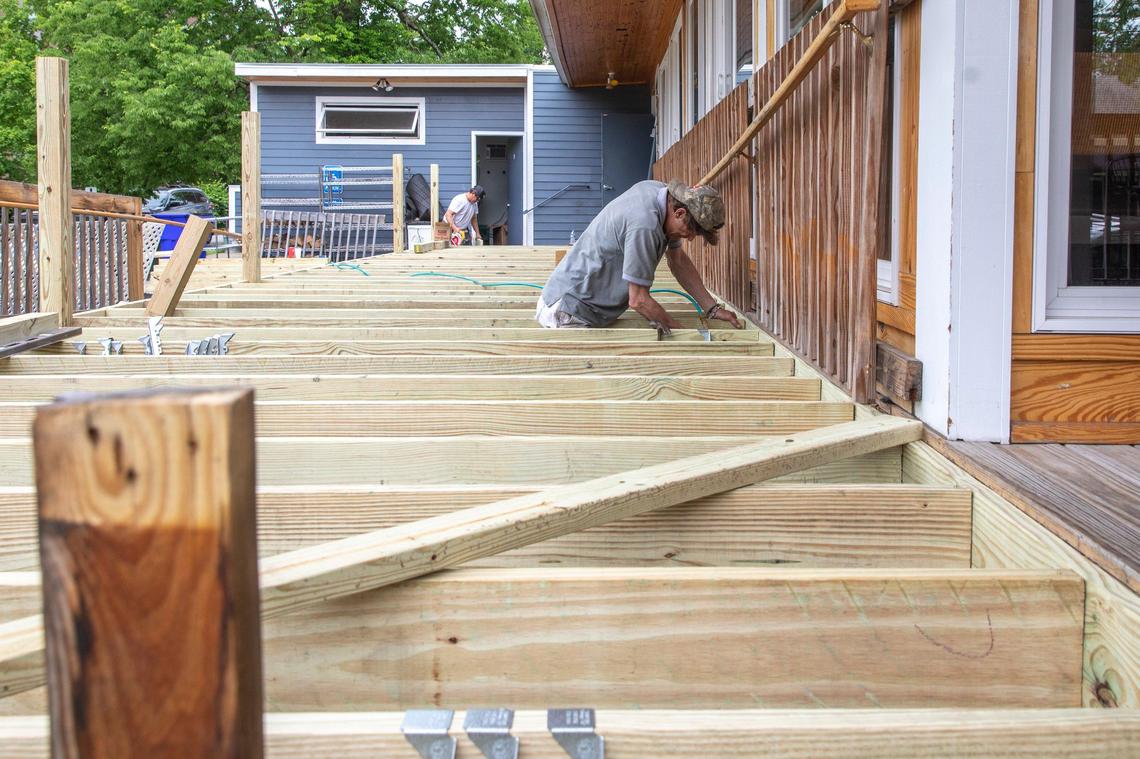 Jack Spence, of Hollingsworth and Associates LLC, helps build a deck Monday outside Blue Heron Steakhouse. The deck will be used to allow for more outside dining space once the restaurant reopens to in-person dining Friday.